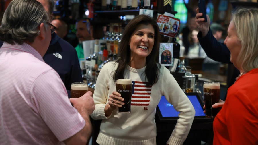 Republican presidential candidate former U.N. Ambassador Nikki Haley enjoys a beer as she visits The Peddler's Daughter on January 20, 2024 in Nashua, New Hampshire. Haley continues to campaign across the state.