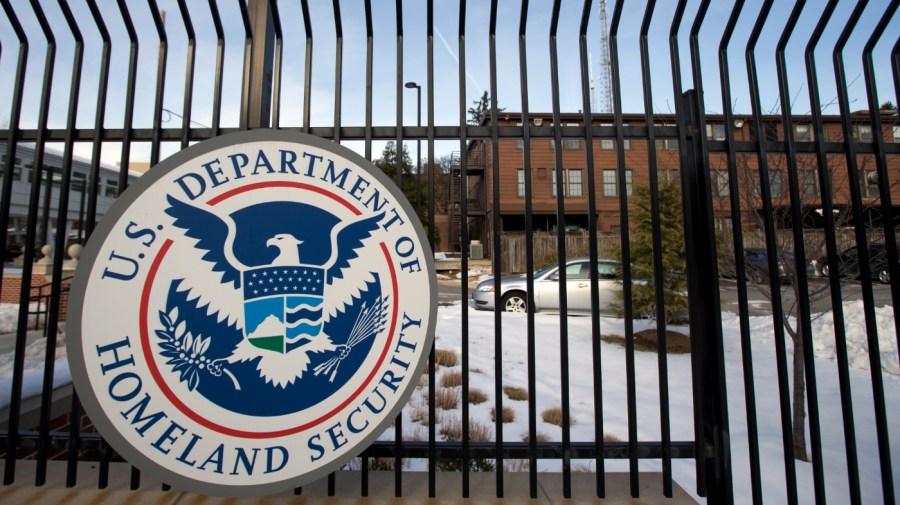 The Homeland Security Department logo is seen on a fence at its headquarters.