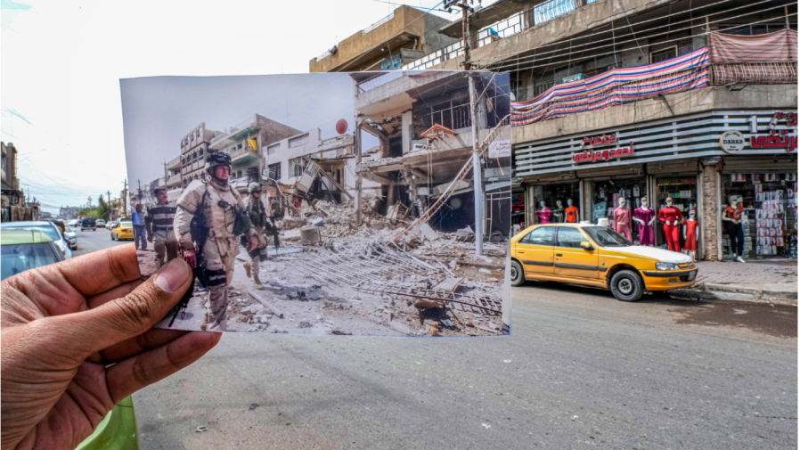 A photo of U.S. troops arriving at the site of a bomb blast in Baghdad's Camp Sara, a mainly Christian neighborhood, Wednesday, Oct. 4, 2006, is inserted into the scene at the same location on Tuesday, March21, 2023, 20 years after the U.S. led invasion on Iraq and subsequent war.