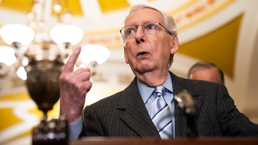 Senate Minority Leader Mitch McConnell gestures while speaking at the Capitol.