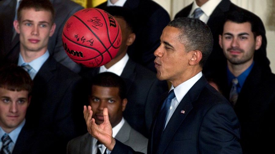 FILE—Then-President Obama tosses a signed basketball in the air given to him by the University of Kentucky mens basketball team in the East Room of the White House in Washington, Friday, May 4, 2012, during a ceremony to celebrate the team's 2012 NCAA college basketball championship. 