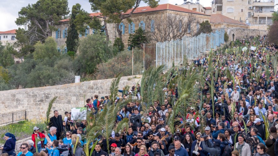 Christians walk in the Palm Sunday procession on the Mount of Olives in east Jerusalem, Sunday, March 24, 2024. (AP Photo/Ohad Zwigenberg)