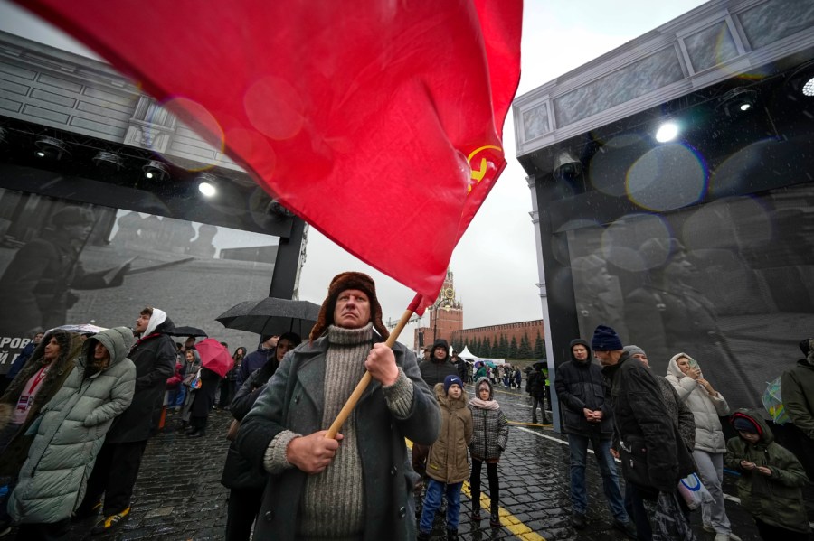 A participant dressed in Red Army World War II uniform in the role of a military traffic controller takes part in a theatrical performance at an open air interactive museum to commemorate the 82nd anniversary of the World War II-era parade, at Red Square, in Moscow, Russia, on Monday, Nov. 6, 2023.