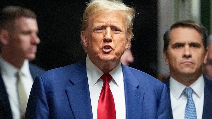 Former President Trump speaks to the press as his lawyer, Todd Blanche, stands in the background.