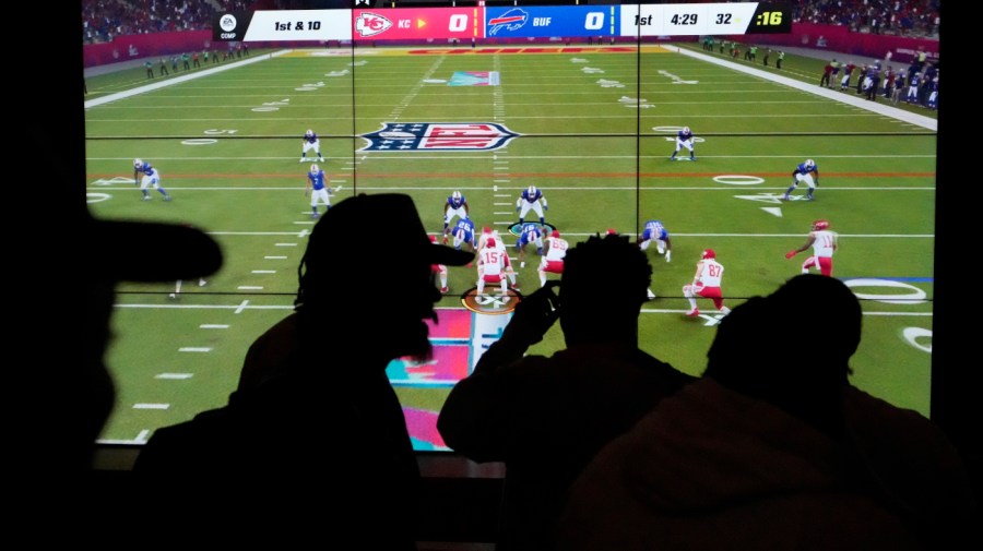 People play EA Sports' Madden NFL video game on a projection screen at Interscope Records Studios In Santa Monica, Calif., Wednesday, June 21, 2023.