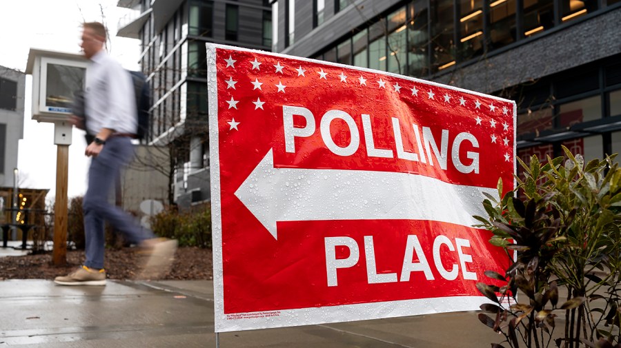 A polling place sign for the primary election is seen outside the H-B Woodlawn Secondary Program in Arlington, Va.