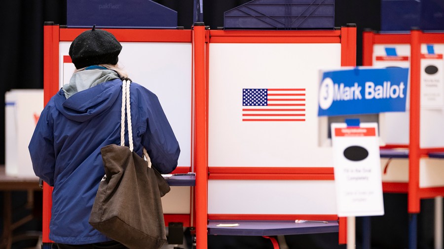 A voter fills out their ballot at the George Mason University’s campus in Arlington, Va.