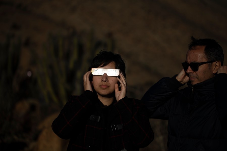 FILE - People watch a total solar eclipse in La Higuera, Chile, Tuesday, July 2, 2019. Small towns and rural enclaves along the path of April’s 2024 total solar eclipse are steeling for huge crowds of sun chasers who plan to catch a glimpse of day turning into dusk in North America. (AP Photo/Esteban Felix, File)