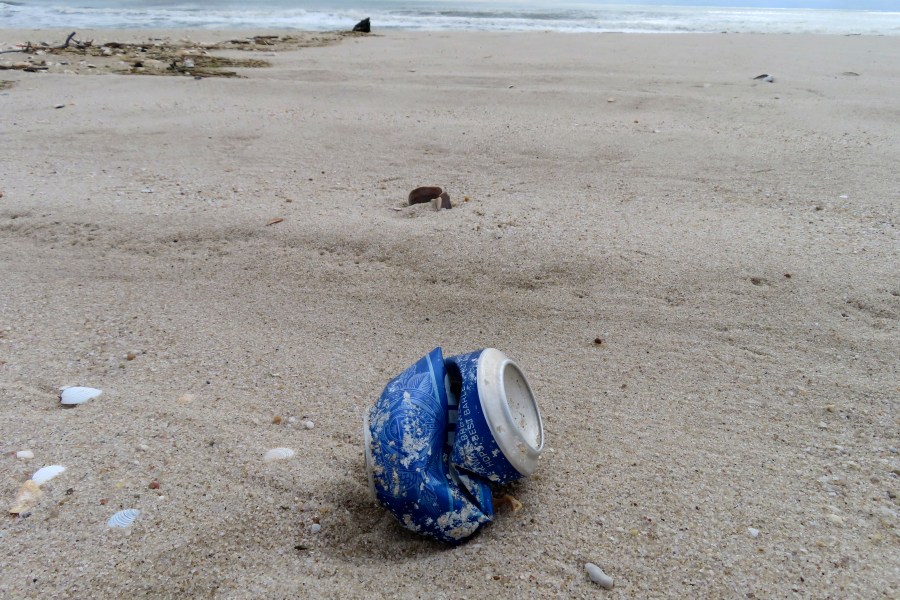 A crushed beverage can sits on the sand in Brick N.J. on Thursday, April 4, 2024, the day that the Clean Ocean Action Environmental Group released a report showing that volunteers picked up and disposed of 176,206 items of trash along New Jersey's 127-mile coastline last year. (AP Photo/Wayne Parry)