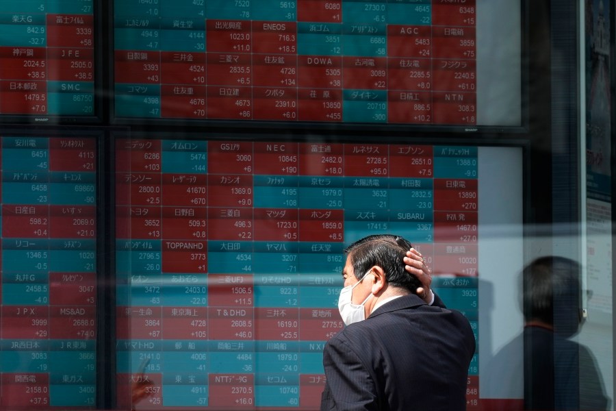 FILE - A person looks at an electronic stock board showing Japan's stock princes at a securities firm Tuesday, April 2, 2024, in Tokyo. Asian shares mostly declined Friday, April 5, after a U.S. Federal Reserve official said the central bank might not deliver any of the interest rate cuts that Wall Street has been banking on this year, citing concerns about inflation. (AP Photo/Eugene Hoshiko, File)