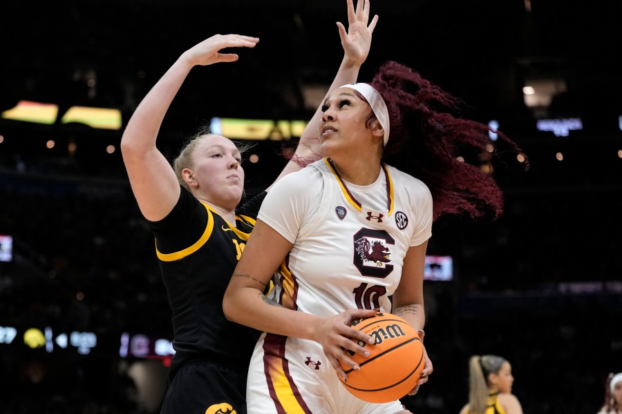 South Carolina center Kamilla Cardoso (10) drives around Iowa forward Addison O'Grady during the first half of the Final Four college basketball championship game in the women's NCAA Tournament, Sunday, April 7, 2024, in Cleveland. (AP Photo/Morry Gash)