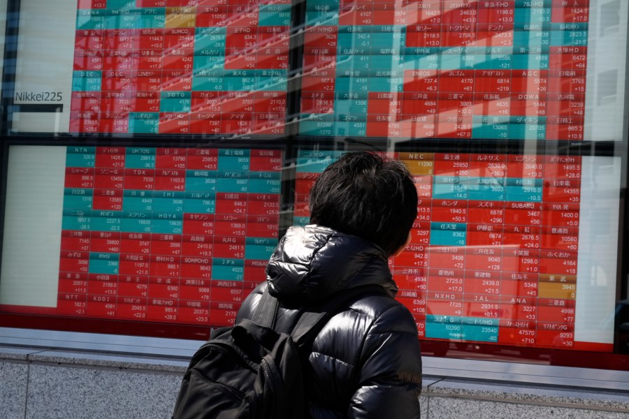 FILE - A person looks at an electronic stock board showing Japan's stock prices at a securities firm in Tokyo, March 22, 2024. Asia stocks were mostly higher on Tuesday, April 9, 2024, with investors mainly focusing on a U.S. inflation report and what it means for interest rate cuts by the Federal Reserve.(AP Photo/Eugene Hoshiko, File)