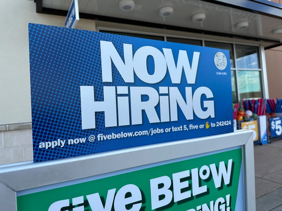 A hiring sign beckons potential employees to apply for work inside a discount store Wednesday, April 3, 2024, in Centennial, Colo. On Thursday, April 11, 2024, the Labor Department reports on the number of people who applied for unemployment benefits last week. (AP Photo/David Zalubowski)