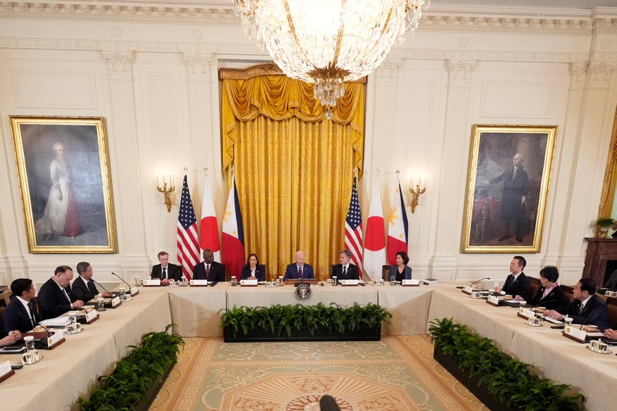 President Joe Biden, center, Philippine President Ferdinand Marcos Jr., left, and Japanese Prime Minister Fumio Kishida, right, attend a trilateral meeting in the East Room of the White House in Washington, Thursday, April 11, 2024. (AP Photo/Mark Schiefelbein)