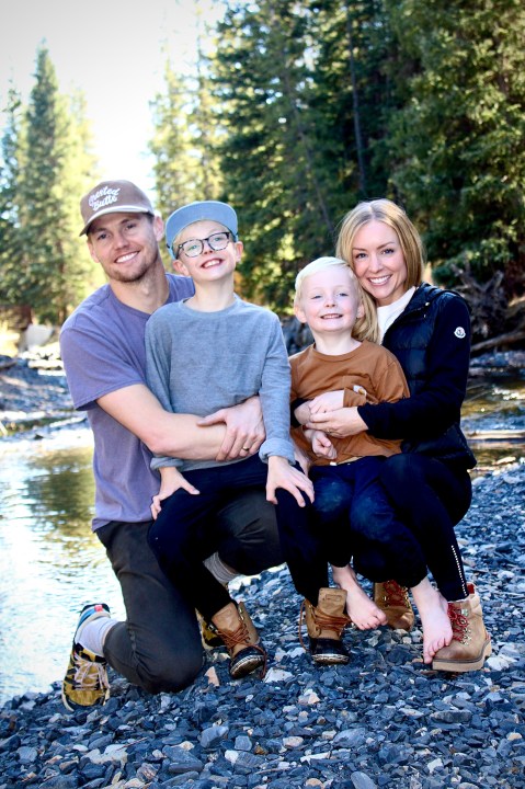 This undated photo released by Cameron Clifford, shows the Clifford family, from left to right; Cameron, Cal, Lyle and Kari who own Terrance, the pet octopus his son Cal adopted at their home in Edmond, Okla. The family soon learned that Terrance was female as she laid 50 eggs that later hatched, with nearly half of them surviving. Although female octopuses usually die soon after laying their eggs, Terrance is still alive four months later. (Cameron Clifford via AP)