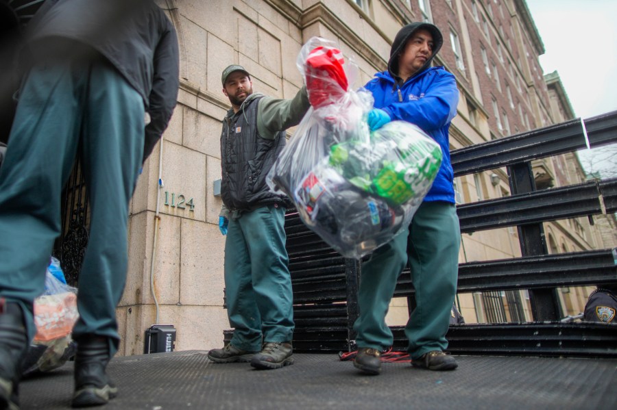 Men load a truck with the belongings of demonstrators who participated in an encampment on the Columbia University campus, Thursday, April 18, 2024, in New York. The protestors were calling for the school to divest from corporations they claim profit from the war in the Middle East. (AP Photo/Mary Altaffer)