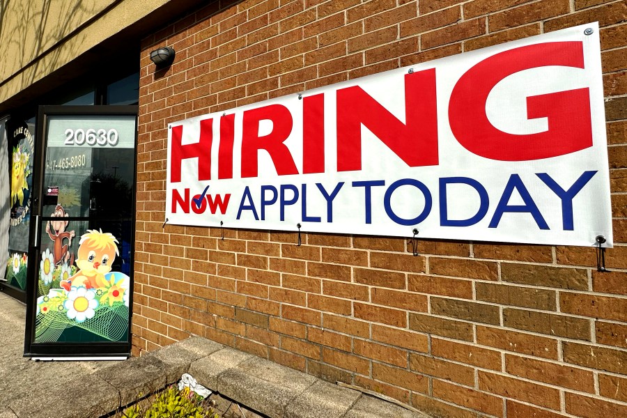 FILE - A hiring sign is displayed in Riverwoods, Ill., Tuesday, April 16, 2024. The Biden administration has finalized a new rule set to make millions of more salaried workers eligible for overtime pay in the U.S. The move marks the largest expansion in federal overtime eligibility seen in decades. (AP Photo/Nam Y. Huh, File)