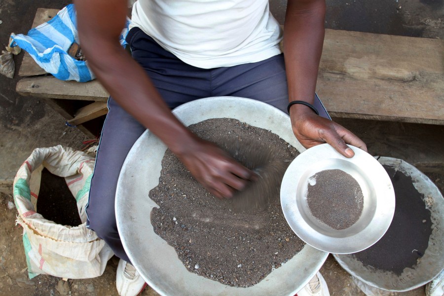 FILE - A Congolese miner sifts through ground rocks to separate out the cassiterite, the main ore that's processed into tin, in the town of Nyabibwe, eastern Congo, Aug. 16, 2012. Congo’s government is questioning Apple about the tech company’s knowledge of “blood minerals” from a conflict zone in the African country that could be smuggled into supply chains. A group of international lawyers representing Congo said Thursday, April 25, 2024, that it sent letters to Apple’s CEO Tim Cook and its French subsidiary this week raising concerns about human rights violations involving the minerals extracted from mines in the country’s war-torn east. (AP Photo/Marc Hofer, File)