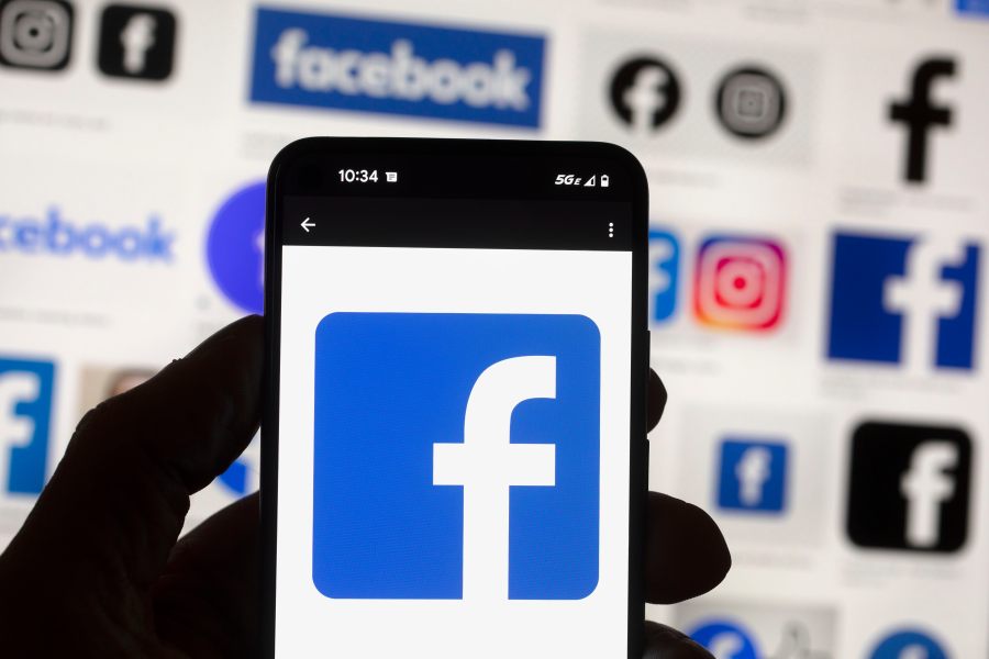 FILE - The Facebook logo is seen on a cell phone in Boston, USA, Oct. 14, 2022. The European Union said Tuesday April 30, 2024 that it's scrutinizing Facebook and Instagram over a range of suspected violations of the bloc's digital rulebook, including not doing enough to protect users from foreign disinformation ahead of EU-wide elections. (AP Photo/Michael Dwyer, File)