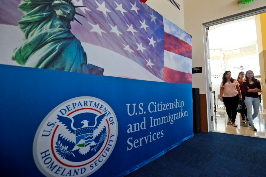 FILE - People arrive before the start of a naturalization ceremony at the U.S. Citizenship and Immigration Services Miami Field Office in Miami, Aug. 17, 2018. Authorities say lottery bids for highly-educated worker visas plunged nearly 40% this year, claiming success against people who were "gaming the system" by submitting multiple, sometimes dubious, applications to unfairly increase their chances. (AP Photo/Wilfredo Lee, File)