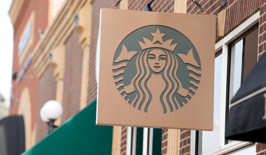 FILE - Starbucks sign hangs outside a casino along Main Street Wednesday, Sept. 20, 2023, in Deadwood, S.D. Starbucks will reports earnings on Tuesday, April 30, 2024. (AP Photo/David Zalubowski)