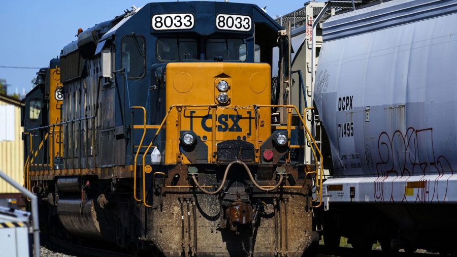 A CSX train engine sits idle on tracks.