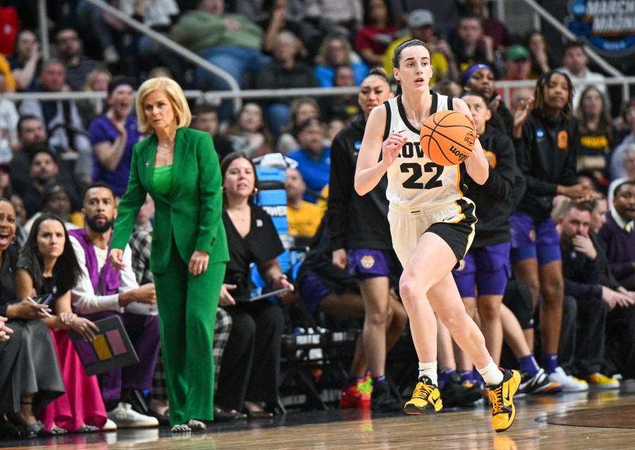 Iowa guard Caitlin Clark (22) moves the ball during a college basketball game.