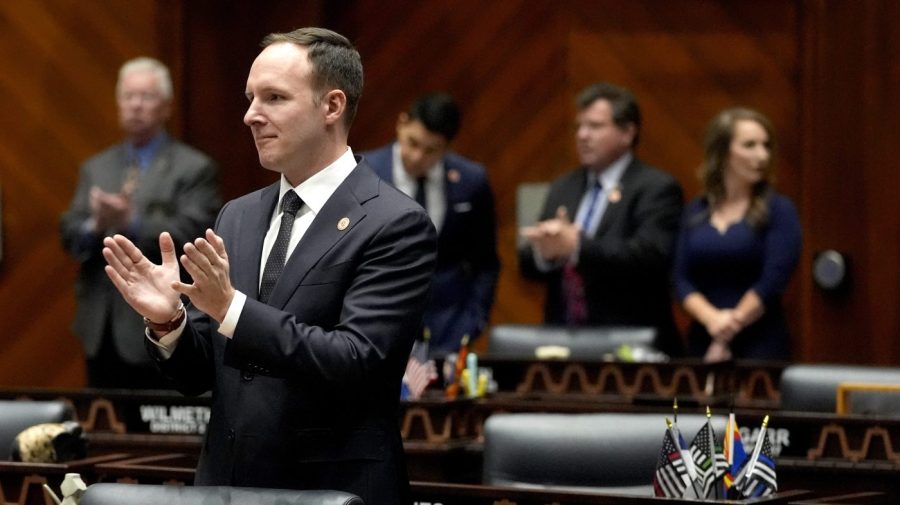 Arizona state Representative Matt Gress applauds from the House floor.