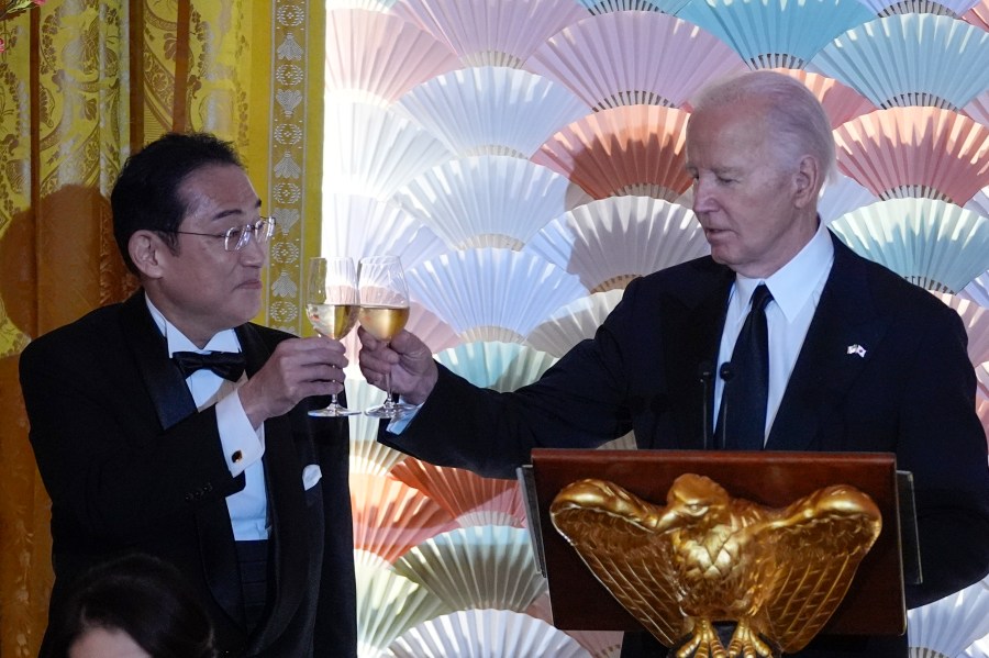 President Joe Biden makes a toast with Japanese Prime Minister Fumio Kishida.