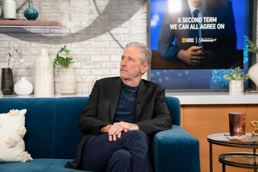 Jon Stewart sits on a couch during a morning talk show segment.