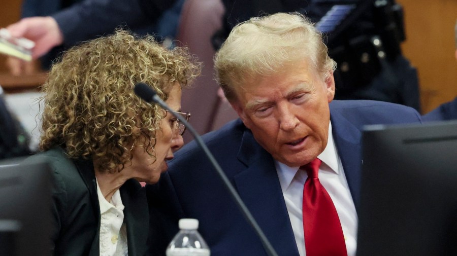 Former President Donald Trump speaks with lawyer Susan Necheles.