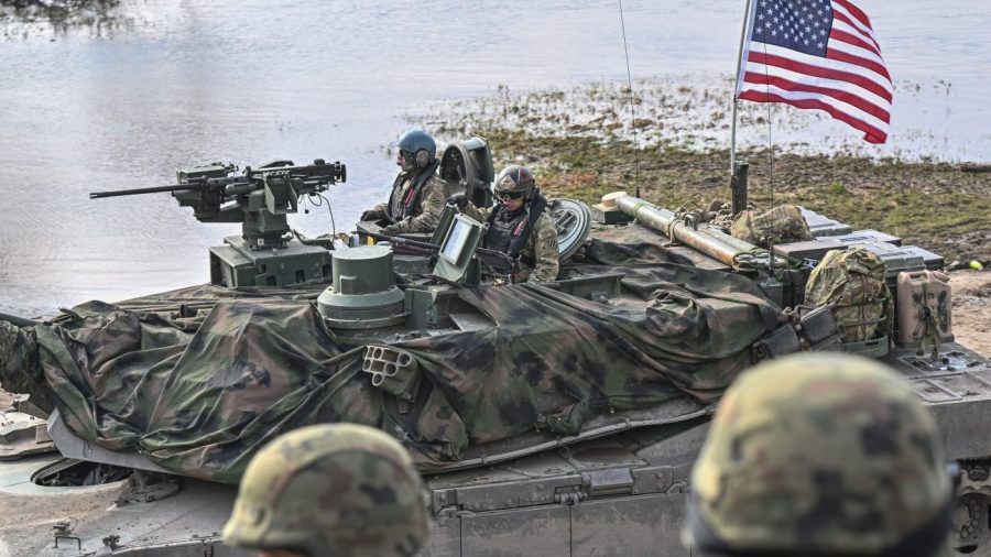 U.S. soldiers operate a tank while participating in a military drill.