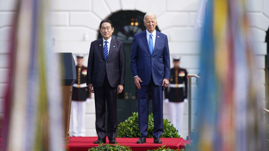 President Biden and Japanese Prime Minister Fumio Kishida stand at an entrance of the White House.