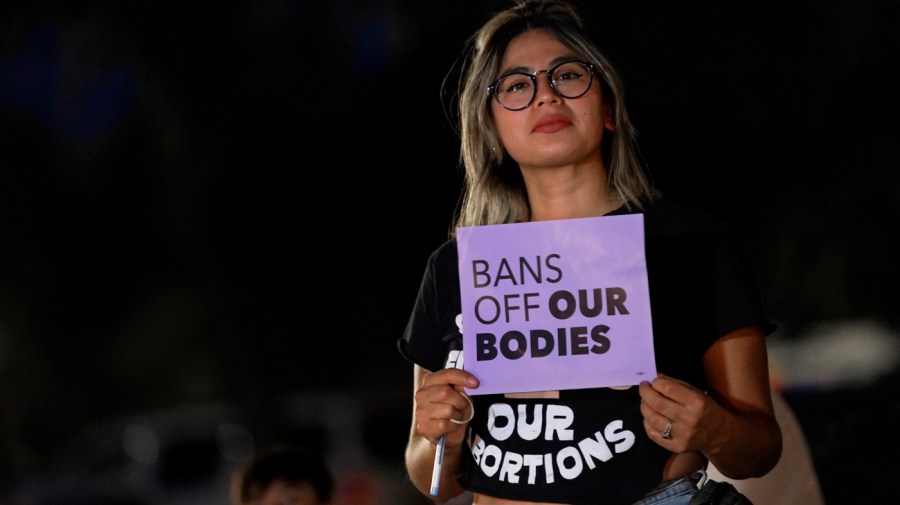 This file photo shows Celina Washburn at a protest on Sept. 23, 2022, outside the Arizona Capitol in Phoenix to voice her opposition to an abortion ruling.