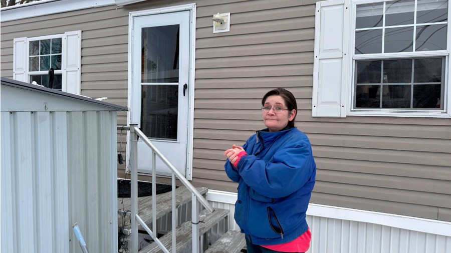 Amy Case stands in her mobile home park Tuesday, Jan. 23, 2024, in Auburn Mass. where residents complain they are facing double-digit rent increases that they cannot afford.