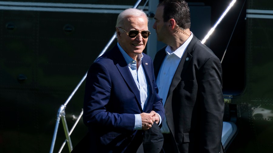 President Biden walks past a security official.