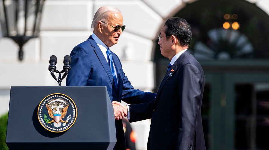 President Biden shakes hands with Japanese Prime Minister Fumio Kishida.