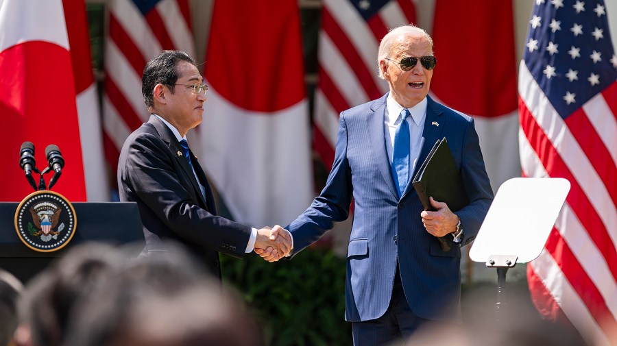 Japanese Prime Minister Kishida Fumio shakes hands with President Biden