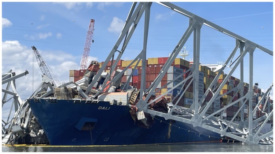 The collapsed Francis Scott Key Bridge is seen resting on the container ship that smashed into it.