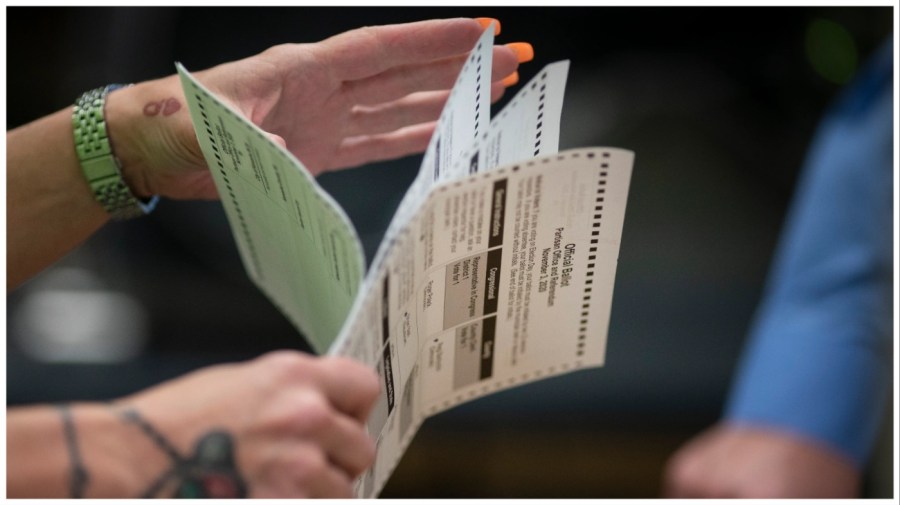 Poll workers sort out early and absentee ballots at the Kenosha Municipal building on Election Day in Kenosha, Wis., Nov. 3, 2020. (AP Photo/Wong Maye-E, File)