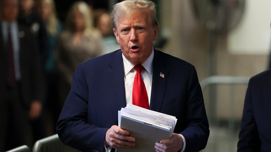 Former President Trump speaks to the media while departing court.