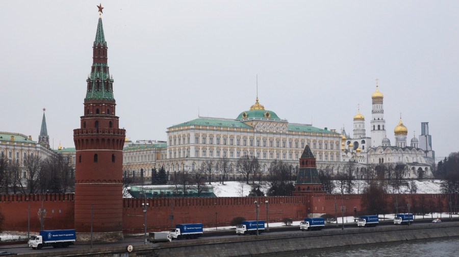 "Kamaz" trucks pass by the Kremlin, as they were presented to the UN World Food Program as a gift from Russia in Moscow, Russia, Tuesday, Dec. 16, 2014. Russia presented first 15 trucks to UN WFP on Tuesday. (AP Photo/Pavel Golovkin)