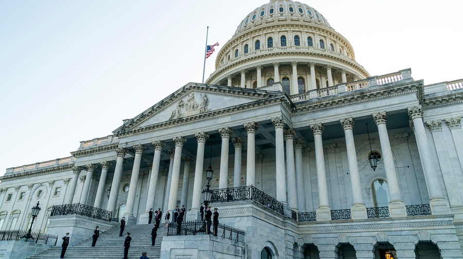 A military honor guard carries the urn of retired U.S. Army Col. Ralph Puckett Jr. down the steps of the U.S. Capitol