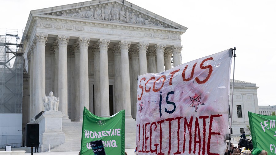 Supporters for abortion hold up signs in a demonstration outside the Supreme Court.