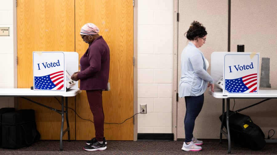 Jessie Harris, left, a registered independent, casts a ballot at Kelly Mill Middle school during South Carolina's Republican Primary on Saturday, Feb. 24, 2024 in Blythewood, S.C.