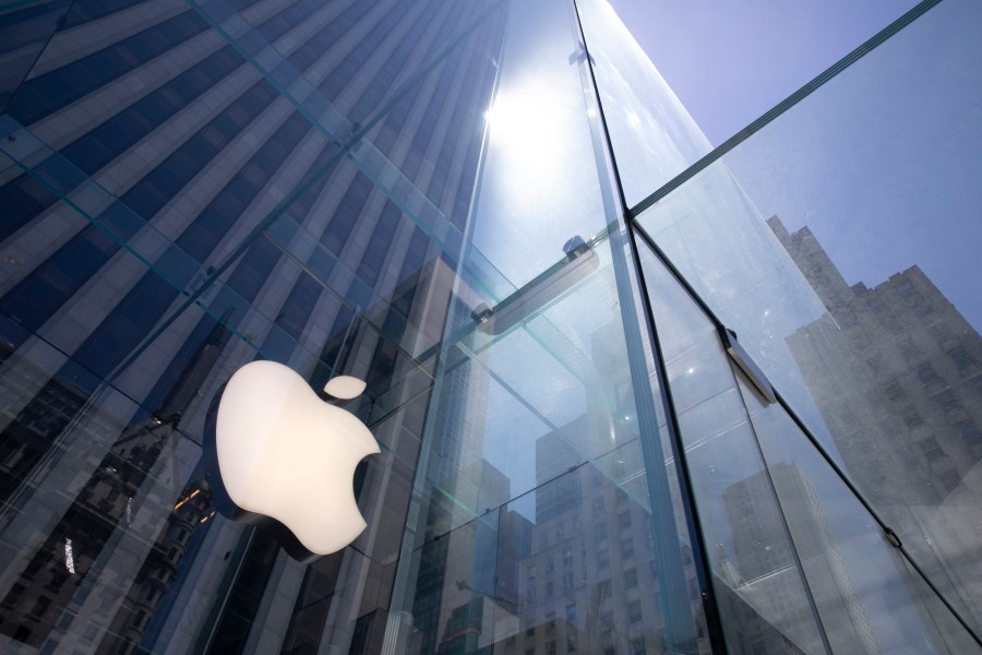 FILE - In this June 16, 2020 file photo, the sun is reflected on Apple's Fifth Avenue store in New York. Apple will reports earnings on Thursday May 2, 2024. (AP Photo/Mark Lennihan, File)