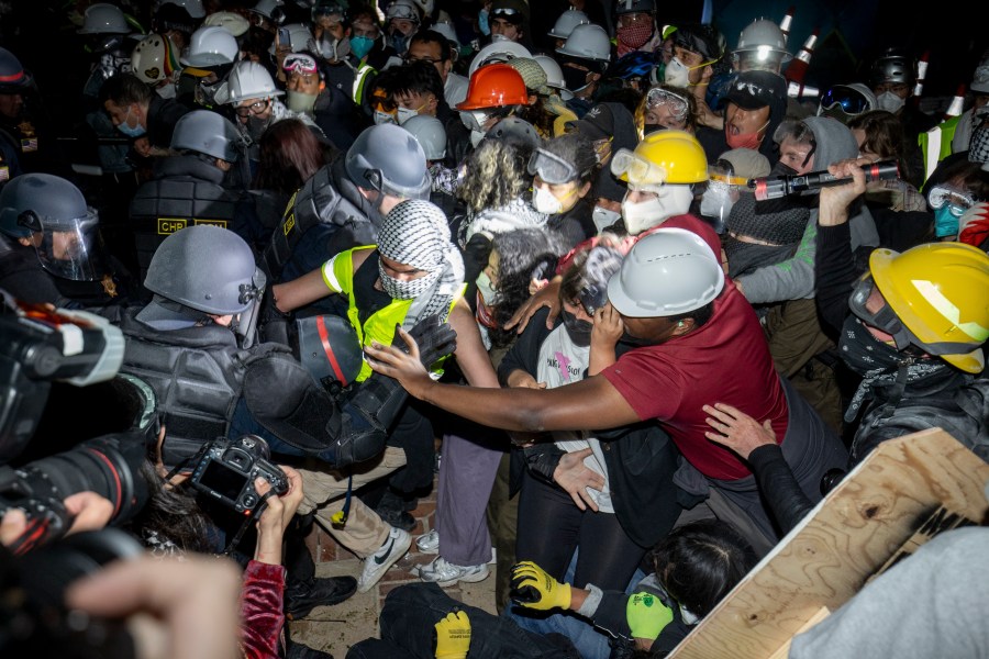 Police advance on pro-Palestinian demonstrators on the UCLA campus Thursday, May 2, 2024, in Los Angeles. (AP Photo/Ethan Swope)