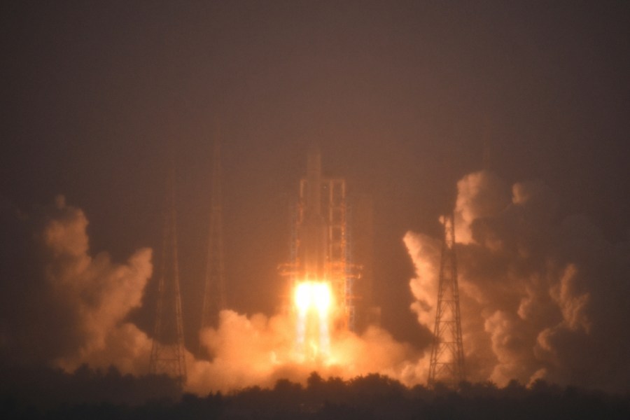 In this photo provided by China's Xinhua News Agency, a Long March-5 rocket, carrying the Chang'e-6 spacecraft, blasts off from its launchpad at the Wenchang Space Launch Site in Wenchang, south China's Hainan Province, Friday, May 3, 2024. China on Friday launched a lunar probe to land on the far side of the moon and return with samples that could provide insights into differences between the less-explored region and the better-known near side. (Guo Cheng/Xinhua via AP)