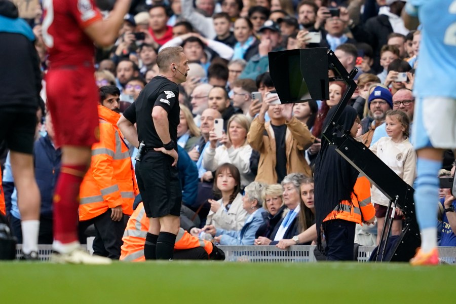 Referee checks VAR for penalty during the English Premier League soccer match between Manchester City and Wolverhampton Wanderers at the Etihad Stadium in Manchester, England, Saturday, May 4, 2024. (AP Photo/Dave Thompson)