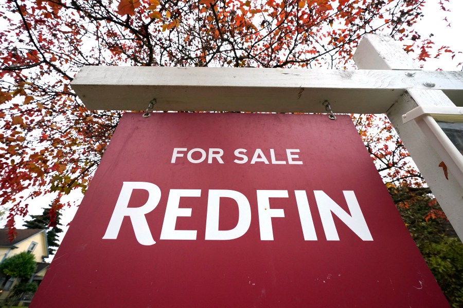 FILE - A Redfin "for sale" sign stands in front of a house on Oct. 28, 2020, in Seattle. Redfin has agreed to pay $9.25 million to settle federal lawsuits that claim U.S. homeowners were saddled with artificially inflated broker commissions when they sold their home as a result of longstanding real estate industry practices. The online brokerage and real estate services company disclosed the proposed settlement Monday, May 6, 2024 in a regulatory filing with the Securities and Exchange Commission. (AP Photo/Elaine Thompson, File)